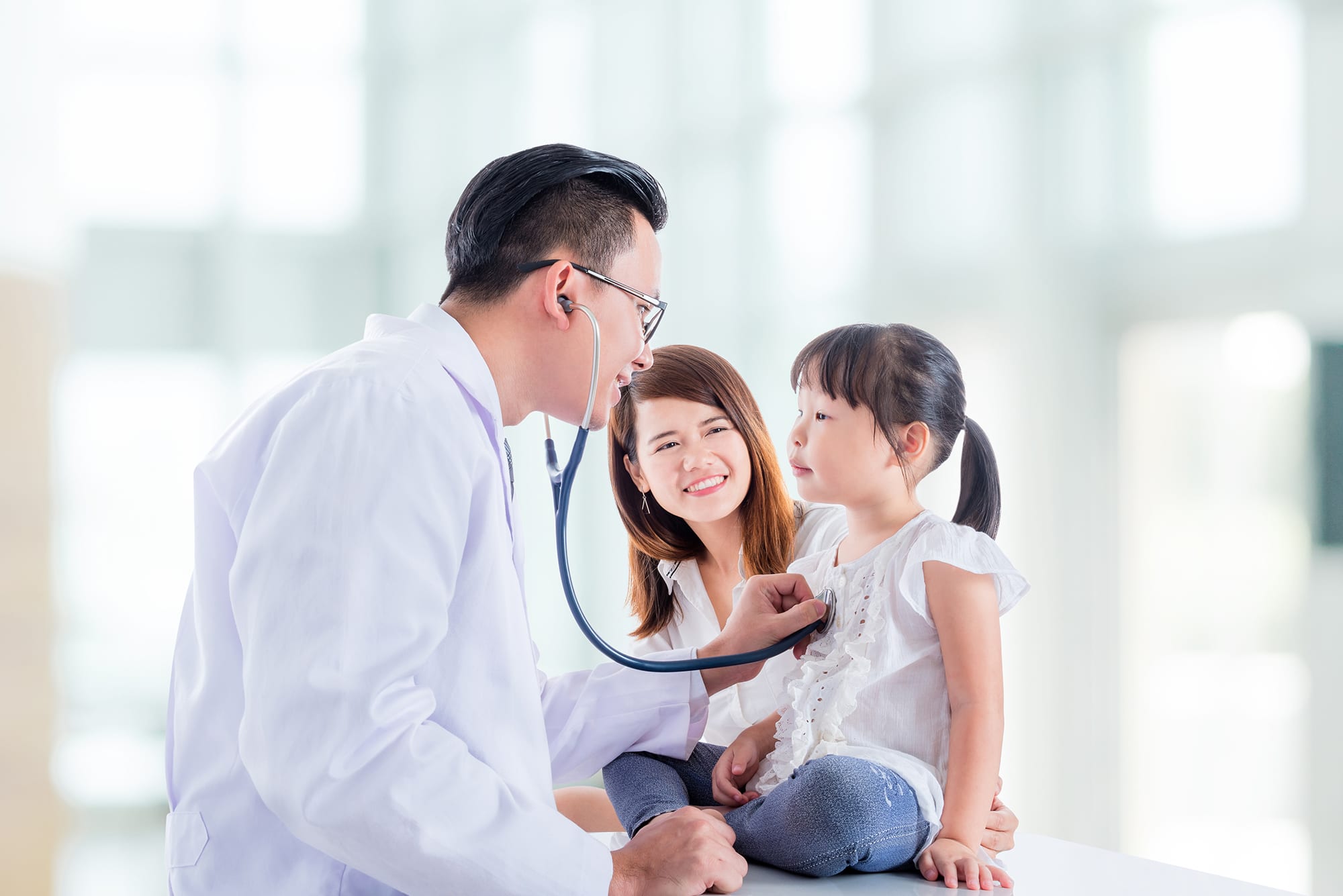 doctor examining a girl by stethoscope