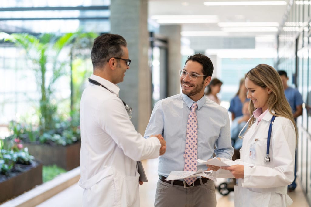 hospital supervisor handshaking with male doctor, Benefits of Being a Locum Tenens Physician